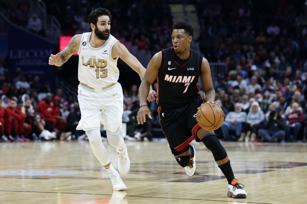Miami Heat guard Kyle Lowry (7) drives against Cleveland Cavaliers guard Ricky Rubio (13) during the second half of an NBA basketball game, Tuesday, Jan. 31, 2023, in Cleveland. (AP Photo/Ron Schwane)