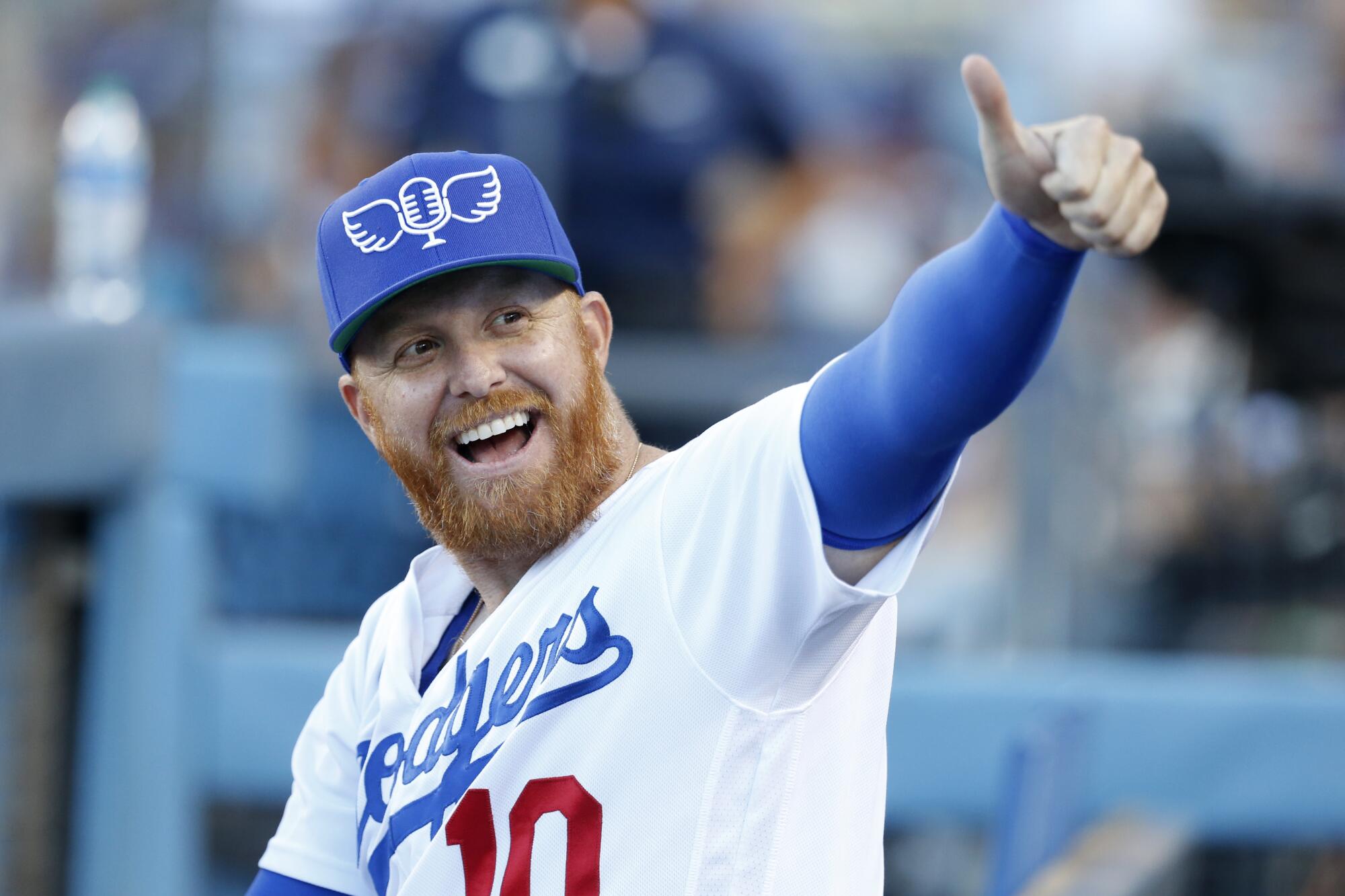 Los Angeles Dodger Justin Turner wears a cap paying tribute to legendary broadcaster Vin Scully.