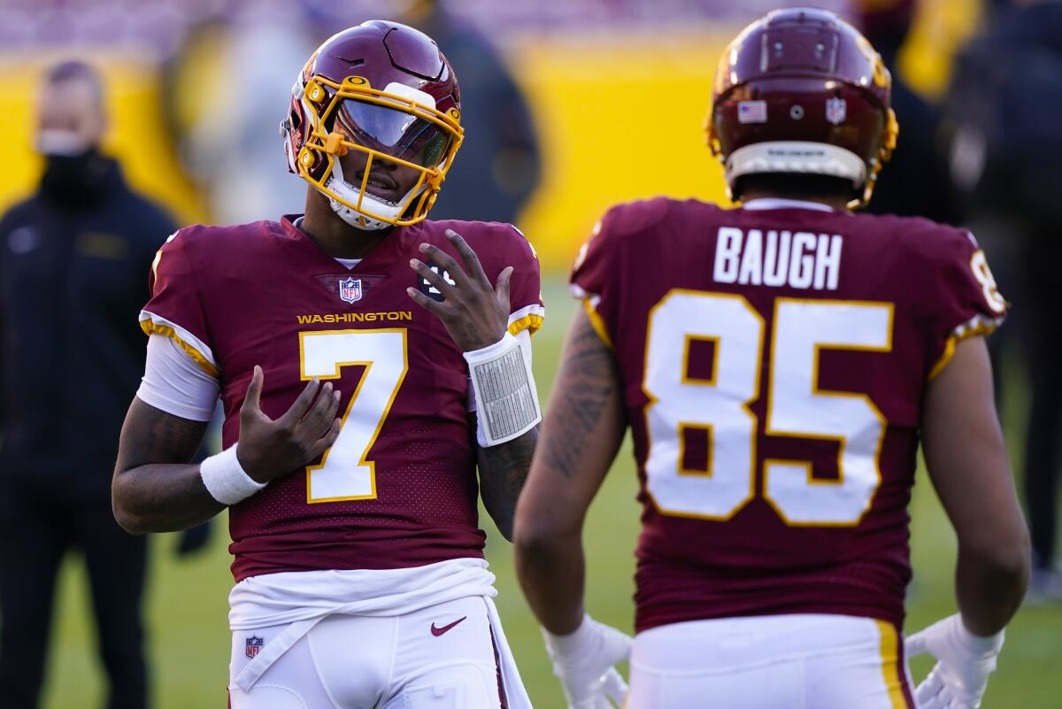 Washington Football Team quarterback Dwayne Haskins speaks with tight end Marcus Baugh.