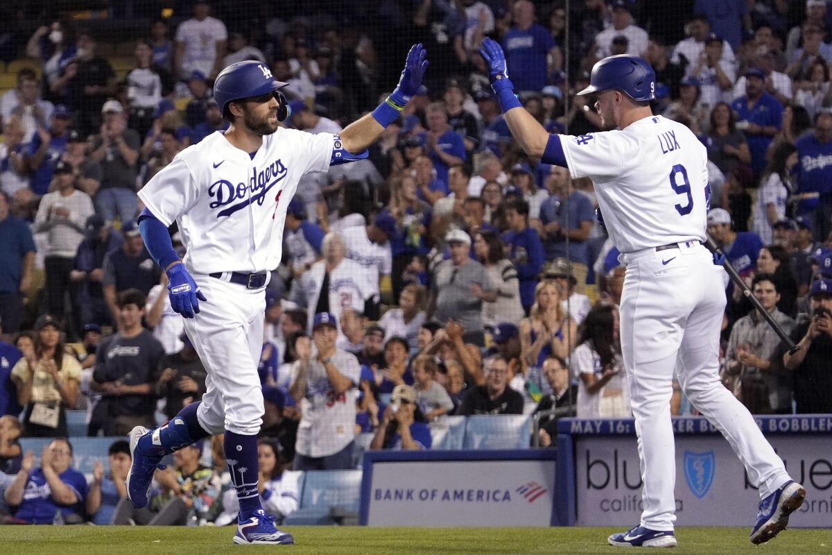 Dodgers' Chris Taylor, left, is congratulated by Gavin Lux after hitting a solo home run during the third inning Friday.