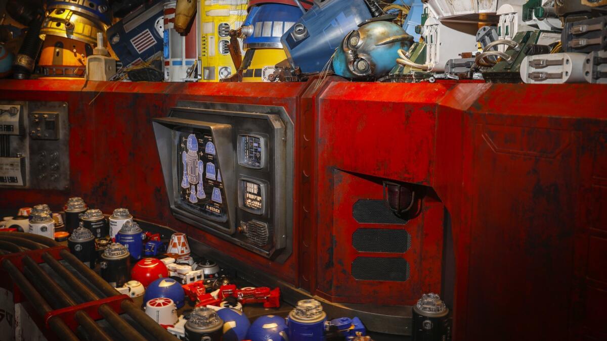Robot parts move along a conveyor belt at Droid Depot, where visitors can pay to build their own droid toys, inside the new "Star Wars: Galaxy's Edge" at Disneyland Resort, in Anaheim on May 29, 2019.