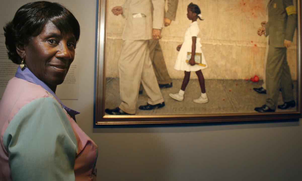 Lucille Bridges poses next to the original 1964 Norman Rockwell painting, "The Problem We All Live With"