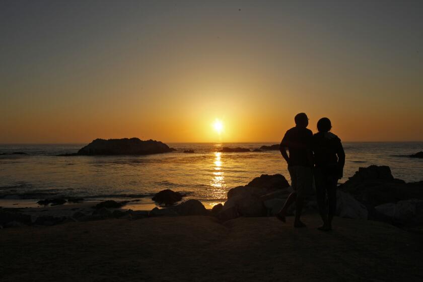 PEBBLE BEACH, CA., APRIL 24, 2013: The sun is about to set behind Bird Rock along 17-Mile Drive in Pebble Beach, California. The drive costs $9.75 while it winds past beaches, around golf courses and through groves of Monterey Cypress trees(Mark Boster/Los Angeles Times).