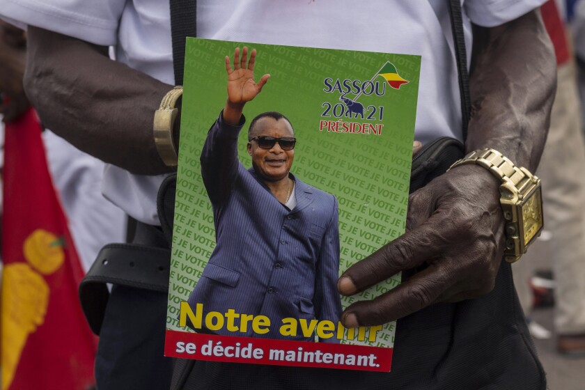 A supporter of President Denis Sassou N'Guesso holds his photo in Brazzaville, Congo. 