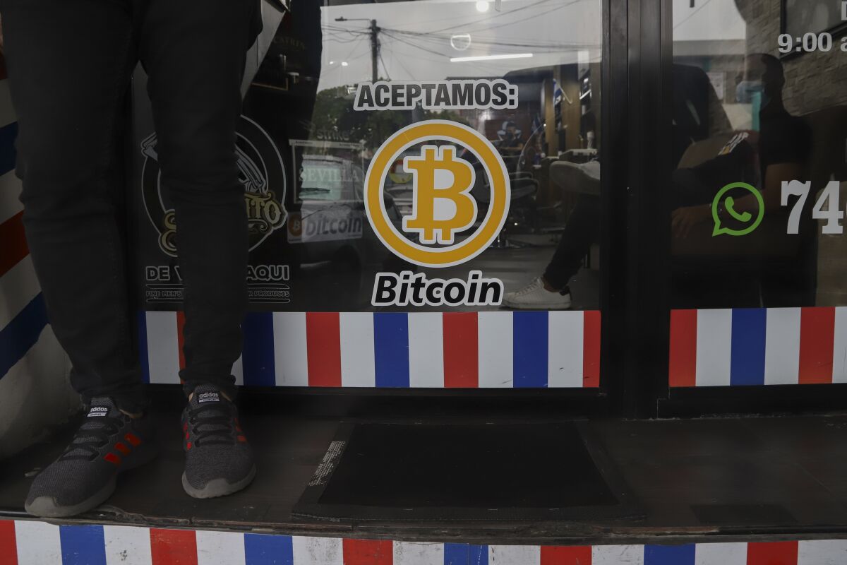"We accept Bitcoin" is announced at a barber shop in Santa Tecla, El Salvador, Saturday, Sept. 4, 2021. Starting Tuesday, Sept. 7, all businesses will have to accept payments in Bitcoin, except those lacking the technology to do so. (AP Photo/Salvador Melendez)
