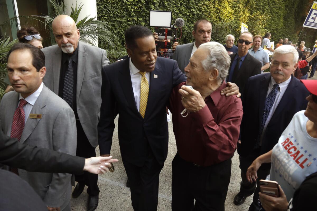 Larry Elder, who is running for governor of California, greets supporters at the Warner Center in Woodland Hills 