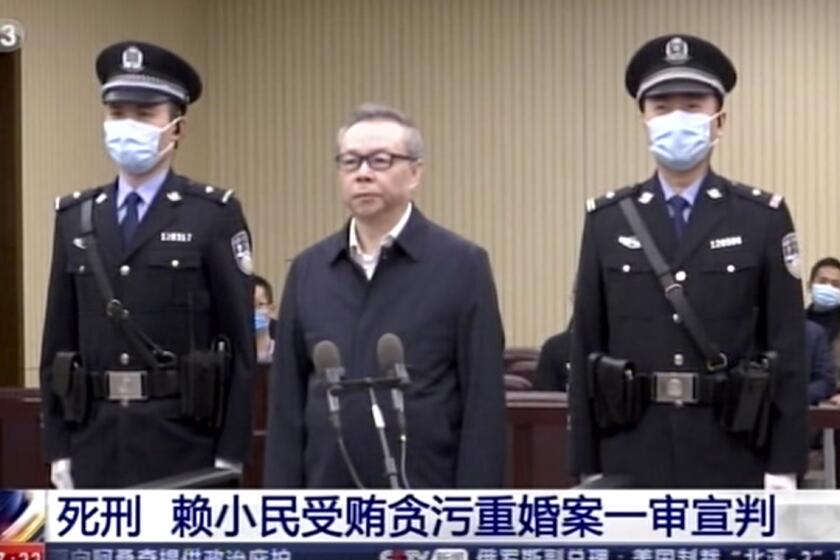 Lai Xiaomin, center, at a court hearing in Tianjin, China, on Jan. 5.