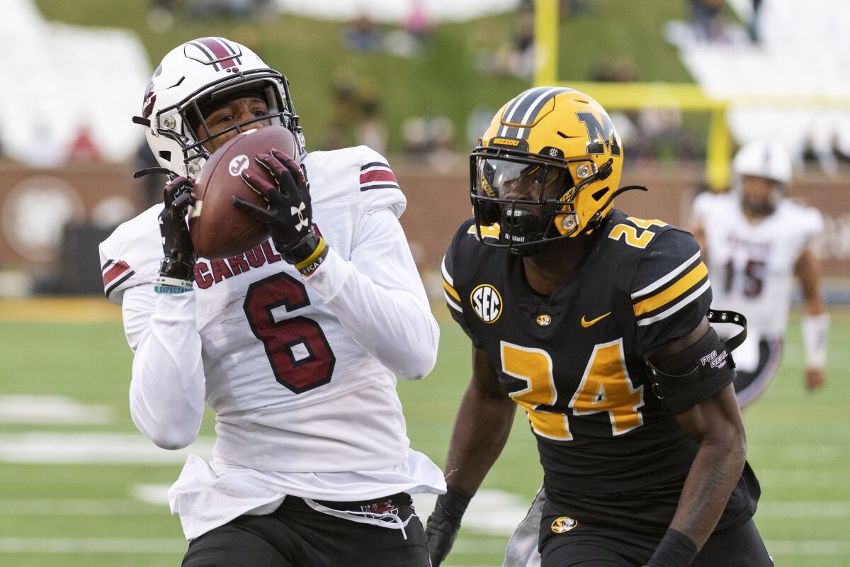 South Carolina wide receiver Josh Vann, left, pulls in a touchdown pass in front of Missouri defensive back Allie Green IV, right, during the second quarter of an NCAA college football game Saturday, Nov. 13, 2021, in Columbia, Mo. (AP Photo/L.G. Patterson)