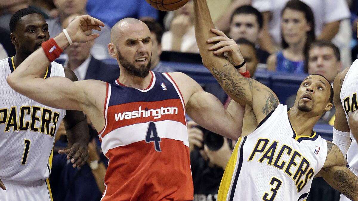 Washington Wizards center Marcin Gortat, left, battles for a rebound with Indiana Pacers guard George Hill during the Wizards' 102-79 win in Game 5 of the NBA Eastern Conference semifinals Tuesday.