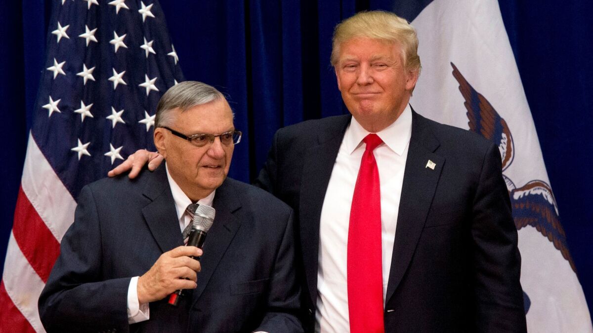 Joe Arpaio, then sheriff of Maricopa County, Ariz., joins Donald Trump at a campaign event in Marshalltown, Iowa, in January 2016.