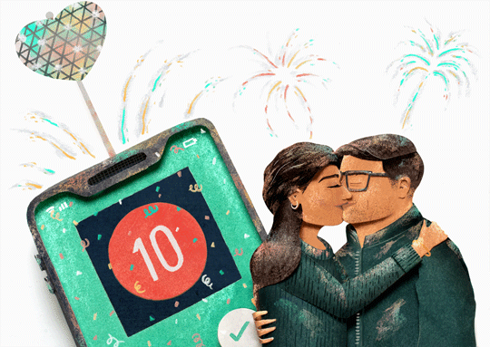 Woman kisses her date as fireworks go off and phone shows the number 10.