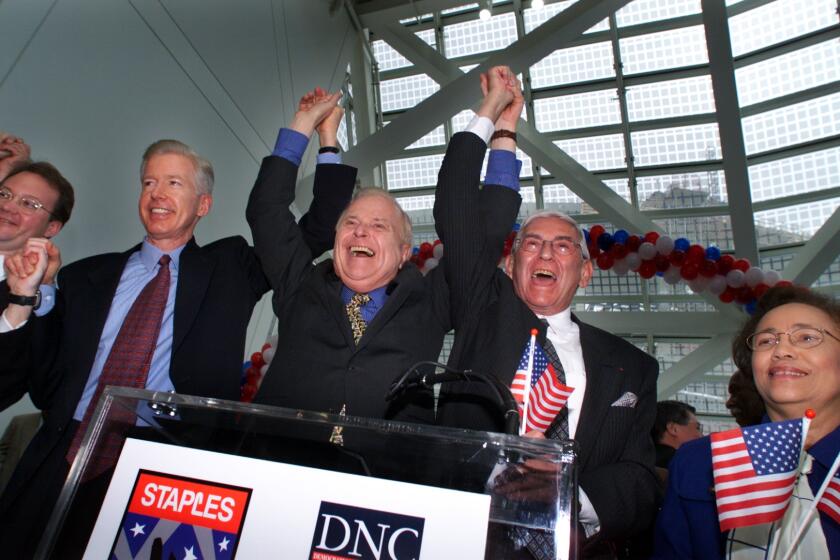 ME.DNC.1.0315.PM––California govenor Gray Davis, left, Los Angeles Mayor Richard Riordan, center, and developer Eli Broad hold there hands high after a press conference announcing the year 2000 Democratic National Convention will be held at the Staples Center. The announcemnet took place at the Los Angeles convention center.