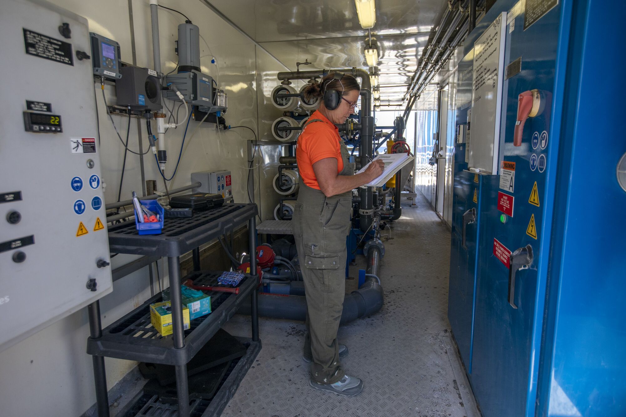 Jessie McDonald checks the numbers inside the desalination plant in Avalon.