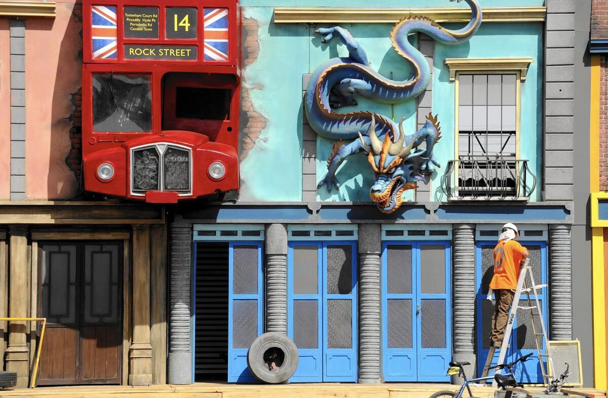 A worker walks through the front of an American-themed street on the grounds of Rock in Rio USA in Las Vegas.