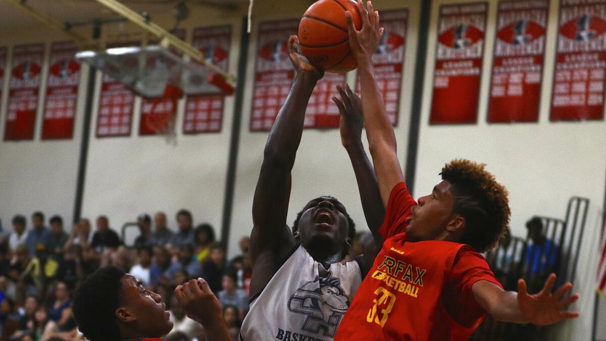 Fairfax's Kirk Smith, right, blocks a shot by Chino Hills' Eli Scott during the Platinum Division championship game on June 25.