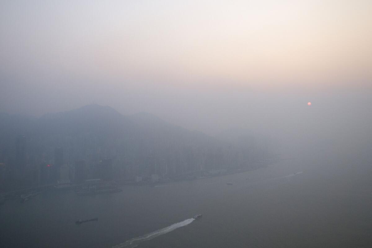 A new study finds the ocean surface can remove a key ingredient of smog from the air near coastal cities. Above, the sun sets through pollution hanging over Hong Kong.