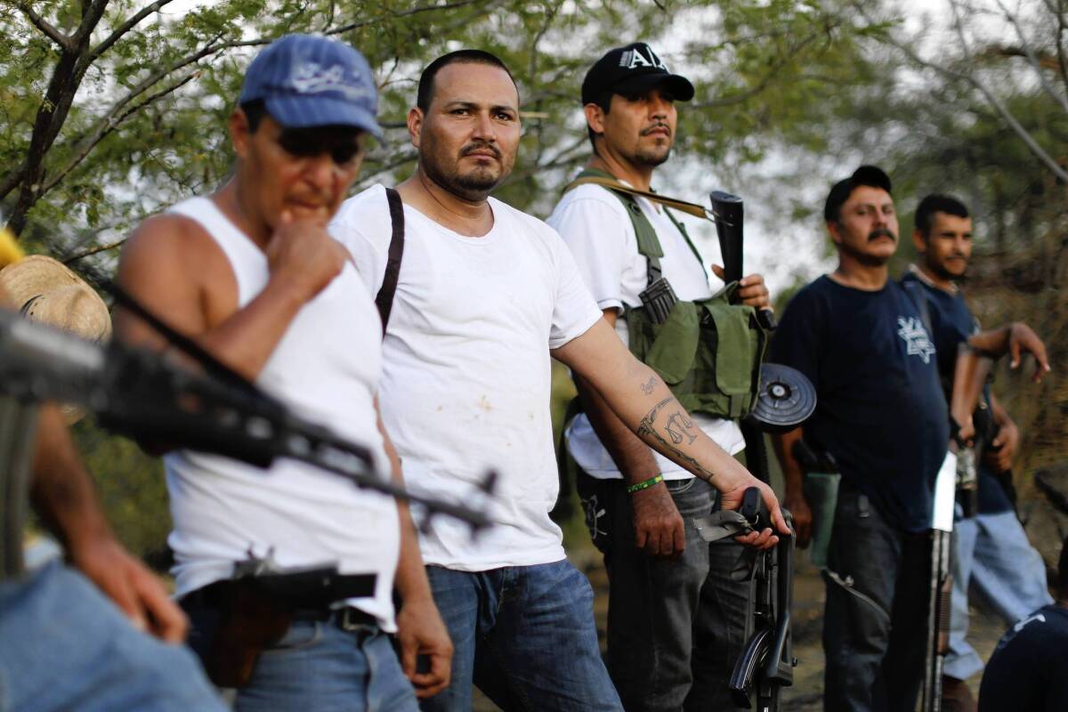 Vigilantes guard a checkpoint in the town of Las Colonias in Mexico’s Michoacan state. Their enemy is the Knights Templar drug cartel.