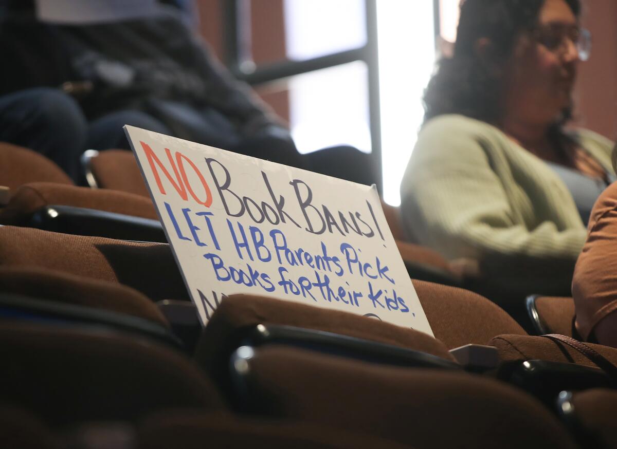 A homemade sign at the Community & Library Services Commission meeting at City Hall in Huntington Beach on Wednesday.