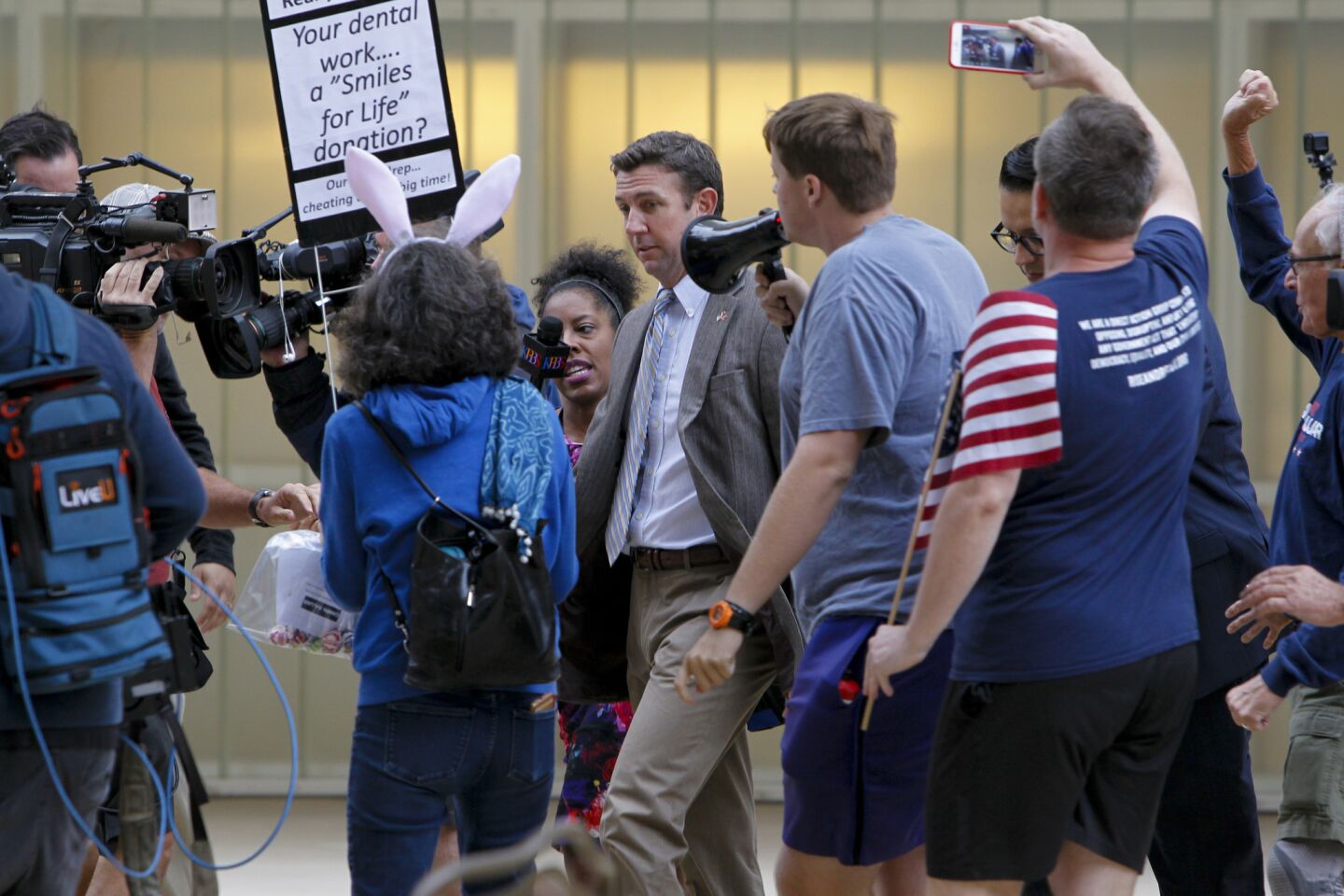 Congressman Duncan Hunter is met with protestors outside as he leaves San Diego federal court Monday morning where he and his wife, Margaret Hunter, appeared for a status hearing. They are charged with misspending political donations on personal items.