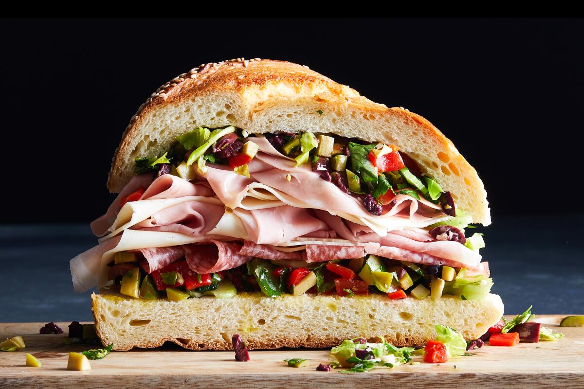 A muffuletta sandwich, with cured meats, cheese and olive salad.