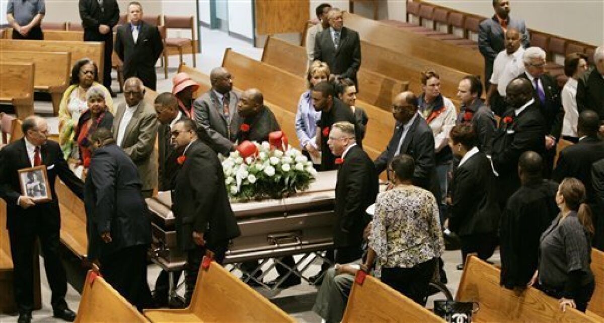 Pallbearers bring the casket of former heavyweight boxing champion Greg Page into Our Lady of Mt. Carmel Church for his funeral in Louisville, Ky., Monday, May 4, 2009. (AP Photo/Ed Reinke)
