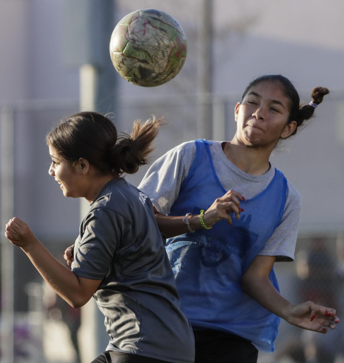 Marianna Hernandez, left, and Ashley Silva of the Downtown LA Soccer Club practice at Liechty Middle School.