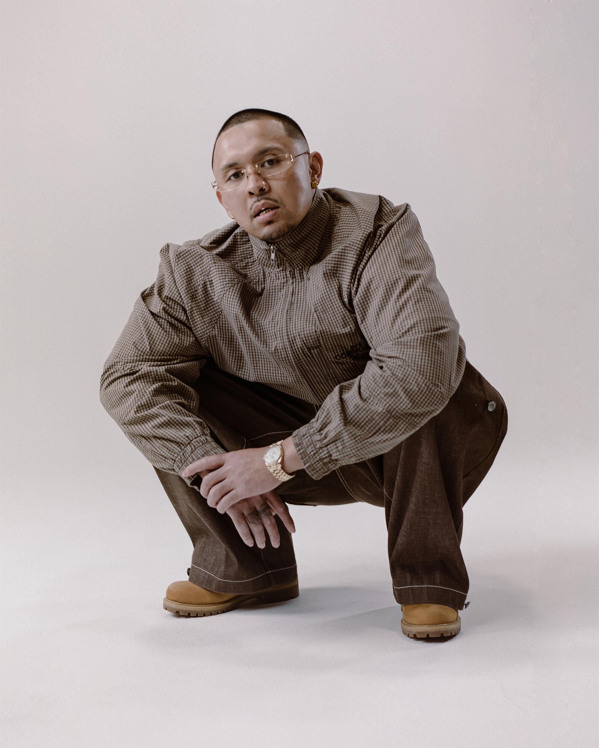 P-Lo wears Art Community Japanese way overgarment and Structured Triptych Japanese Denim pants, FAMILY by Coen Clemente Cross