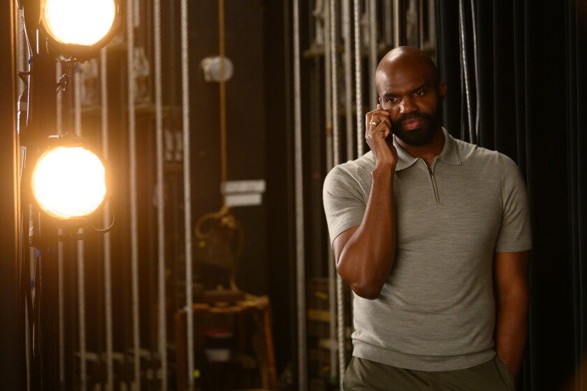 A man talking on a cellphone backstage.