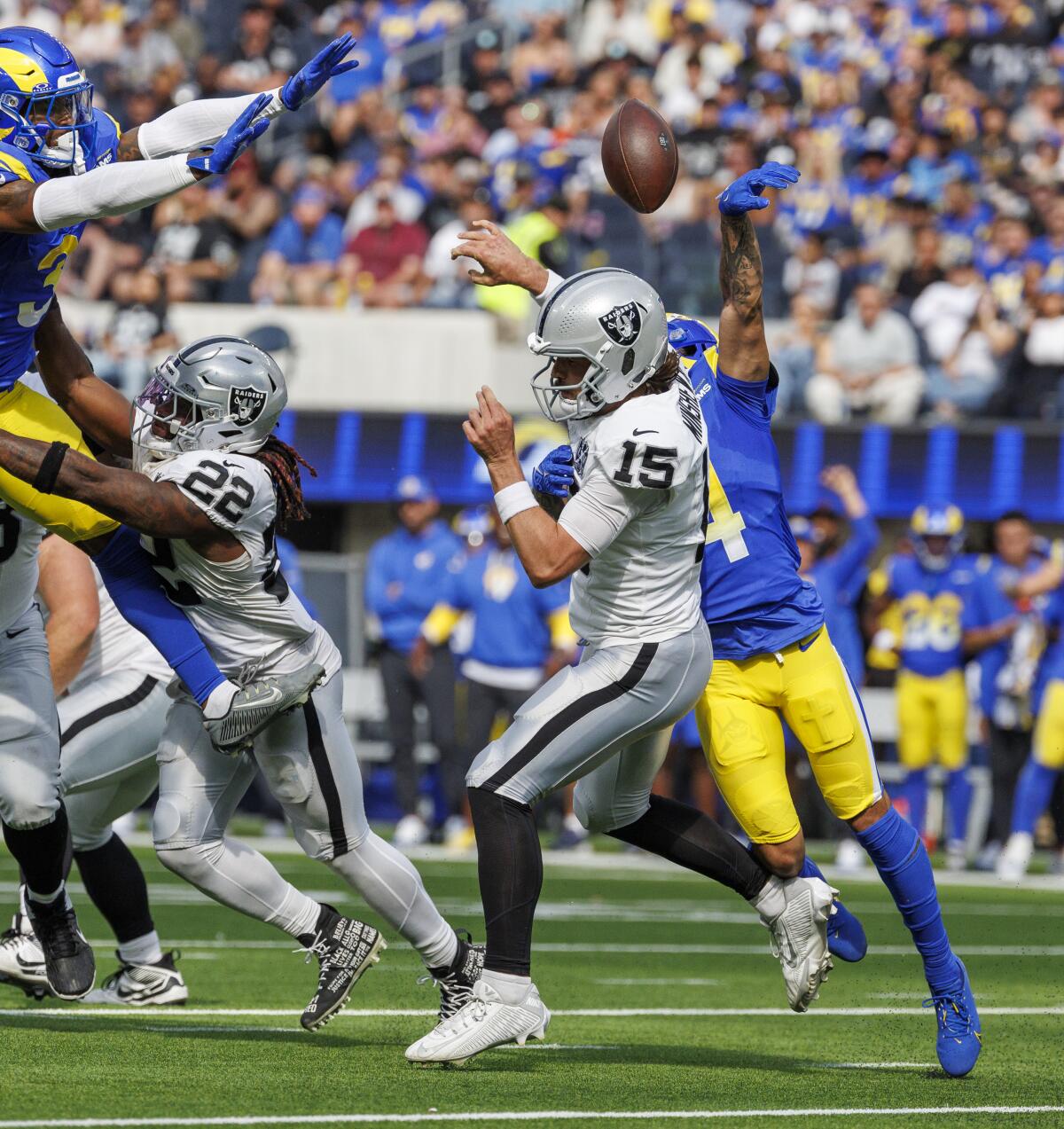 The Rams' Cobie Durant (14) forces a fumble as he hits the Raiders' quarterback Gardner Minshew (15). 