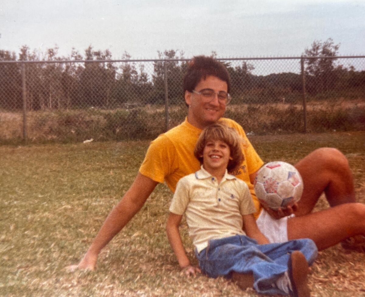 A young Andrew Ladores smiles with his father, Kenneth.