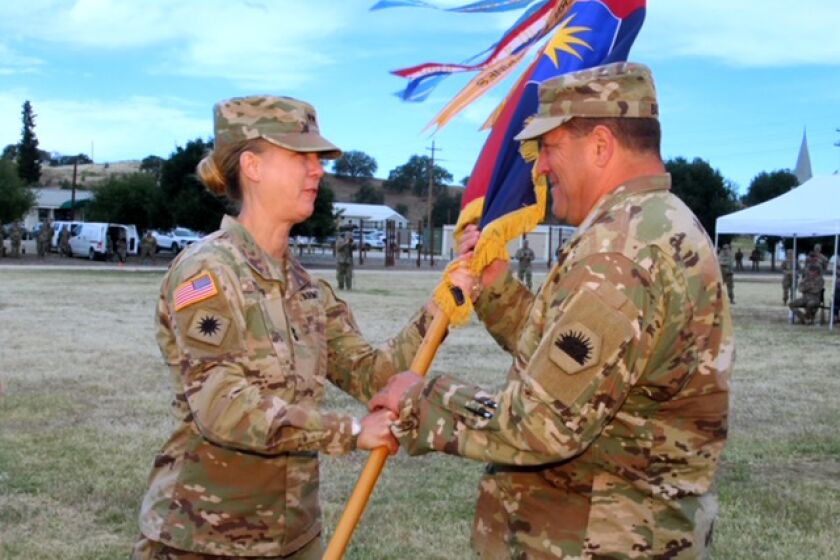 Maj. Gen. Laura Yeager hands off the 40th Infantry Division's battle colors to Maj. Gen. David S. Baldwin, adjutant general of California, during the change of command ceremony on May 15 at Camp Roberts, San Luis Obispo.