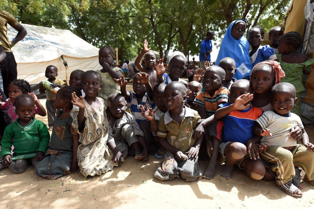 Children at a displaced persons camp in Maiduguri, in northeast Nigeria, wave to a visitor on Feb. 4. Maiduguri has been among the cities worst affected by Boko Haram Islamists' deadly insurgency.