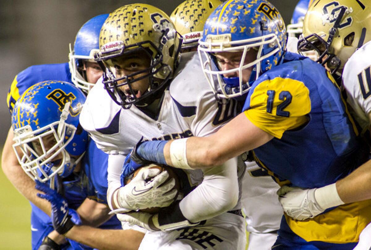 Central Catholic running back Montell Bland powers his way into the end zone against Bakersfield Christian defenders Hayden Kuchta (12) and Zach Balfanz (left) on Friday night in the CIF Division IV bowl game at StubHub Center.