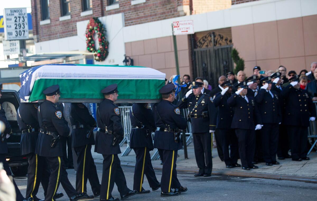 The casket of New York City Police Officer Rafael Ramos is carried into Christ Tabernacle Church in Queens before his wake Friday.