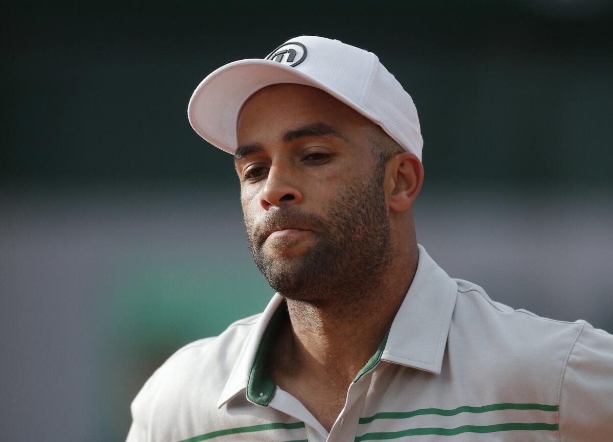 James Blake grimaces after missing a return at the French Open in May 2013.
