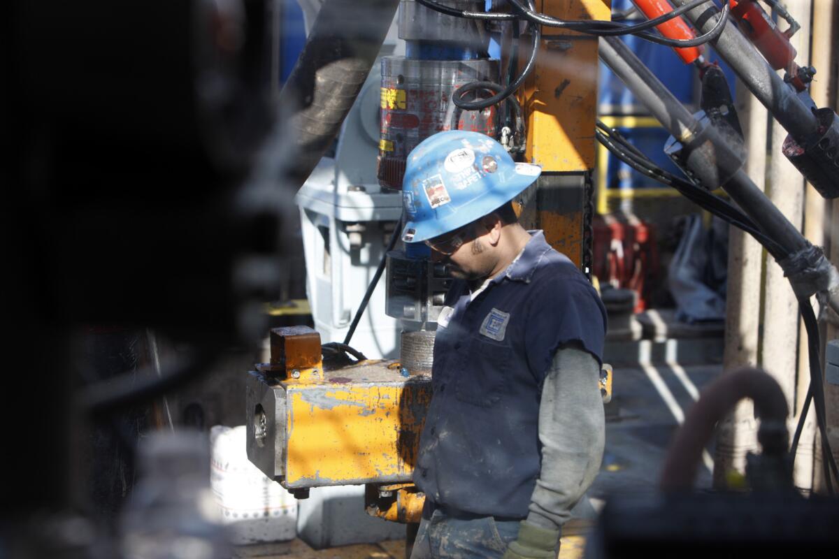 Energy Transfer Equity is acquiring Williams Cos. in a $32.61-billion deal. Above, a worker checks a bit at a Williams Cos. natural gas well in Rulison, Colo., in 2009.