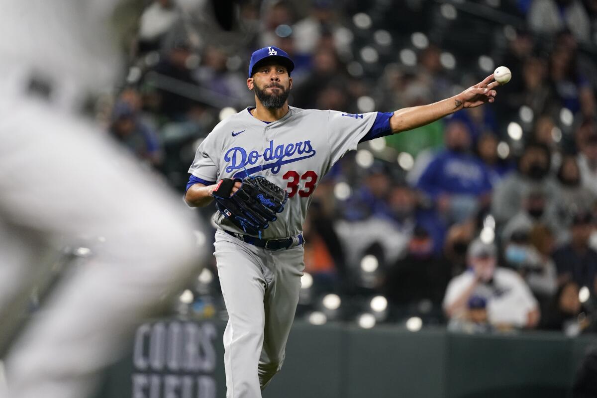 Dodgers relief pitcher David Price throws to first base to put out Colorado Rockies' C.J. Cron on April 2 in Denver.