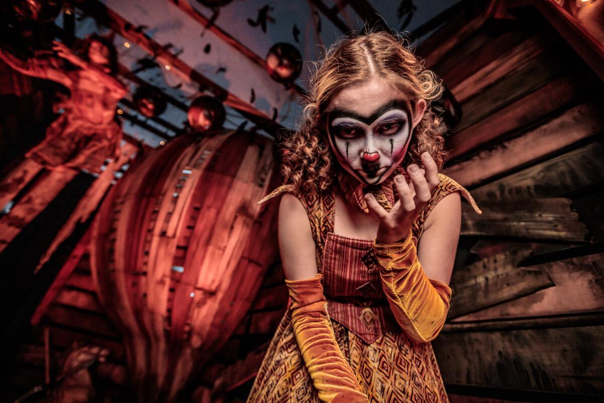 A creepy woman in circus makeup.