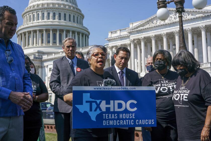 Texas state Rep. Senfronia Thompson, dean of the Texas House of Representatives, is joined by Sen. Jeff Merkley, D-Ore., left center, and other Texas Democrats, as they continue their protest of restrictive voting laws, at the Capitol in Washington, Friday, Aug. 6, 2021. (AP Photo/J. Scott Applewhite)