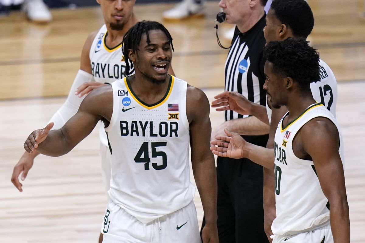 Baylor's Davion Mitchell, left, and Adam Flagler celebrate during a Sweet 16 game against Villanova on March 27, 2021.