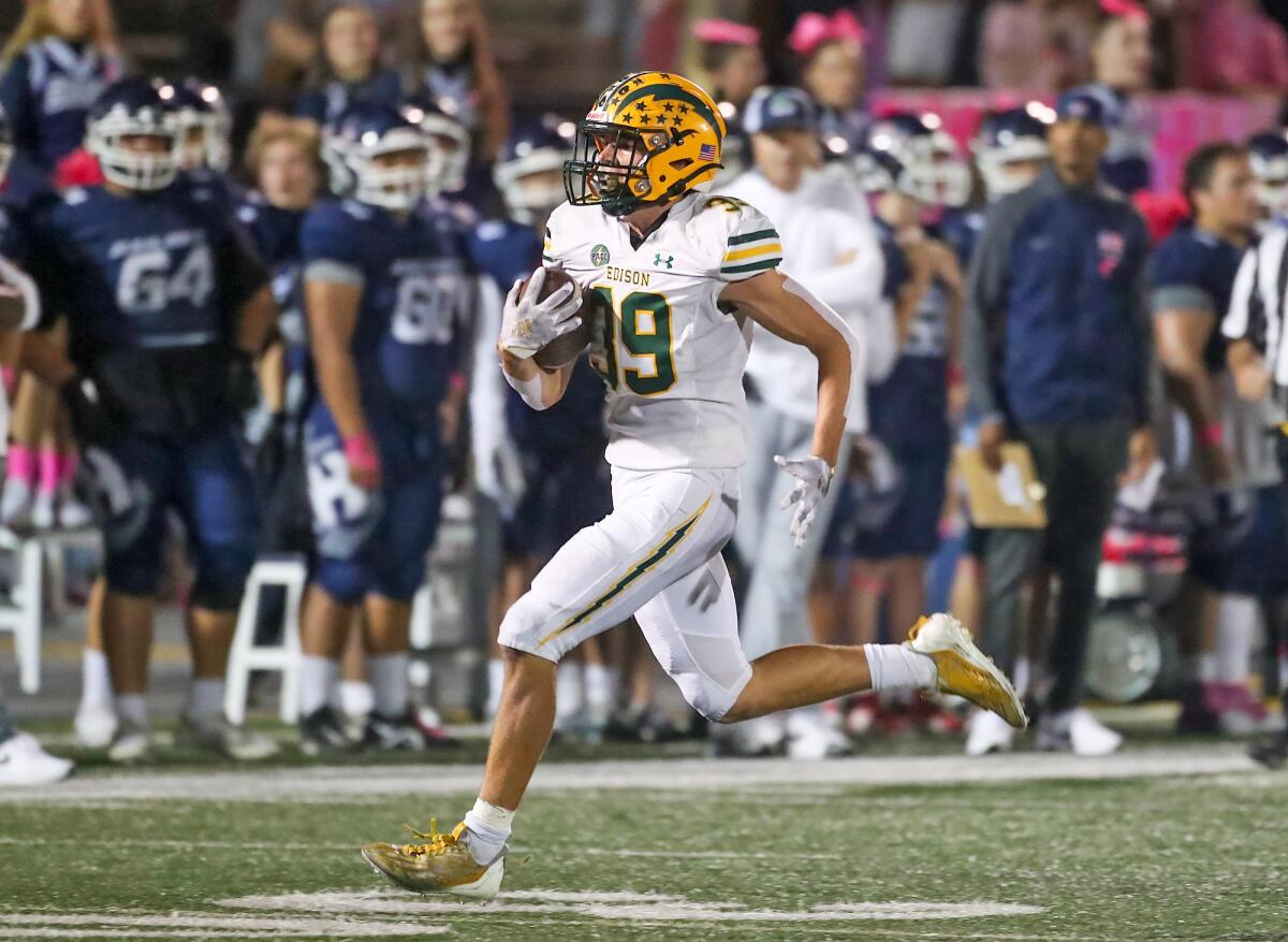 Edison's Carter Hogue hits his stride into the end zone in a Sunset League football game against Newport Harbor on Friday.