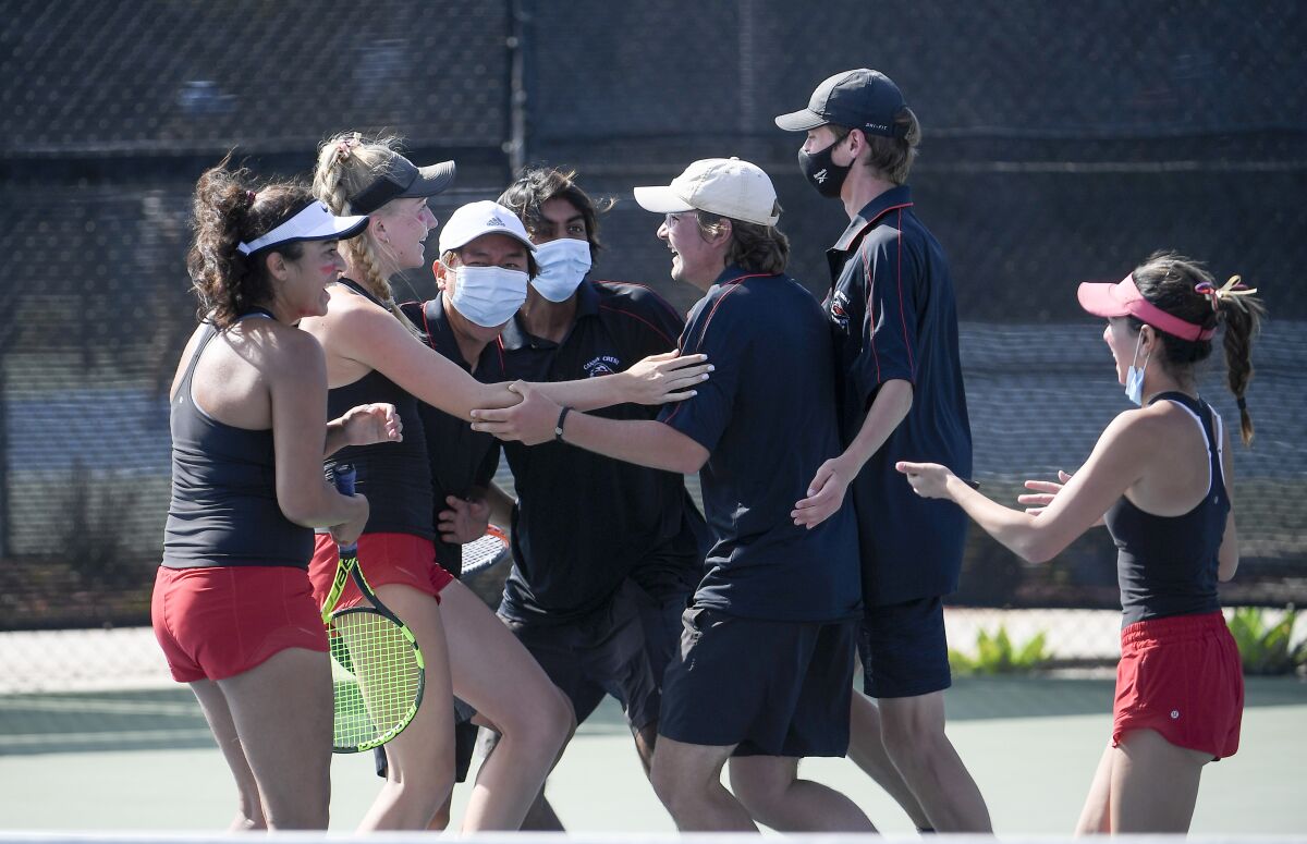 Canyon Crest players celebrate after beating Torrey Pines in the coed tennis Open Division championship on Thursday.