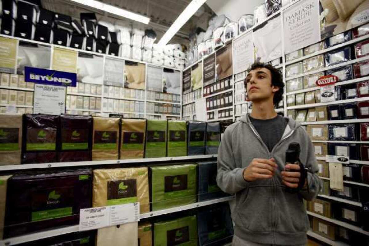 Daniel Gordon, then 18, shops for his freshman year using a scanner at Bed Bath and Beyond in Los Angeles in 2010. The company is buying Cost Plus for $495 million.