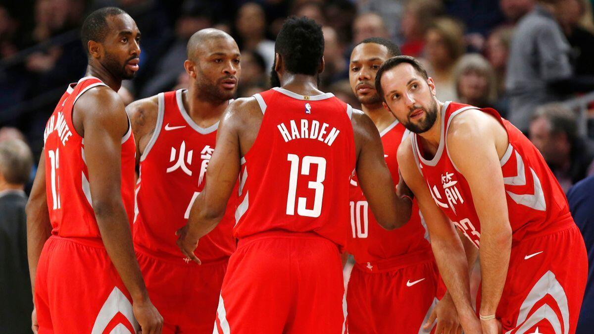 Rockets guard James Harden (13) huddles with teammates, from left, Luc Mbah a Moute, P.J. Tucker, Eric Gordon and Ryan Anderson during a game against the Timberwolves on Tuesday.