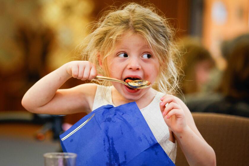 San Diego, CA - April 23: Ahava Aghassi-Cary, 4, of San Diego, eats her soup during Congregational Seder at Temple Emanu-El on Tuesday, April 23, 2024 in San Diego, CA. (Meg McLaughlin / The San Diego Union-Tribune)