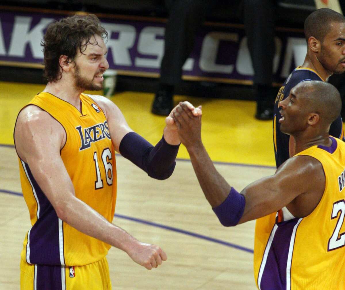 Lakers guard Kobe Bryant gives a high-five to power forward Pau Gasol.