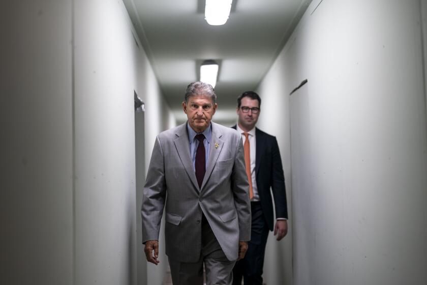 WASHINGTON, DC - JUNE 14: Sen. Joe Manchin (D-WV) walks through a temporary hallway to a Democratic policy luncheon on Capitol Hill on Tuesday, June 14, 2022 in Washington, DC. (Kent Nishimura / Los Angeles Times)