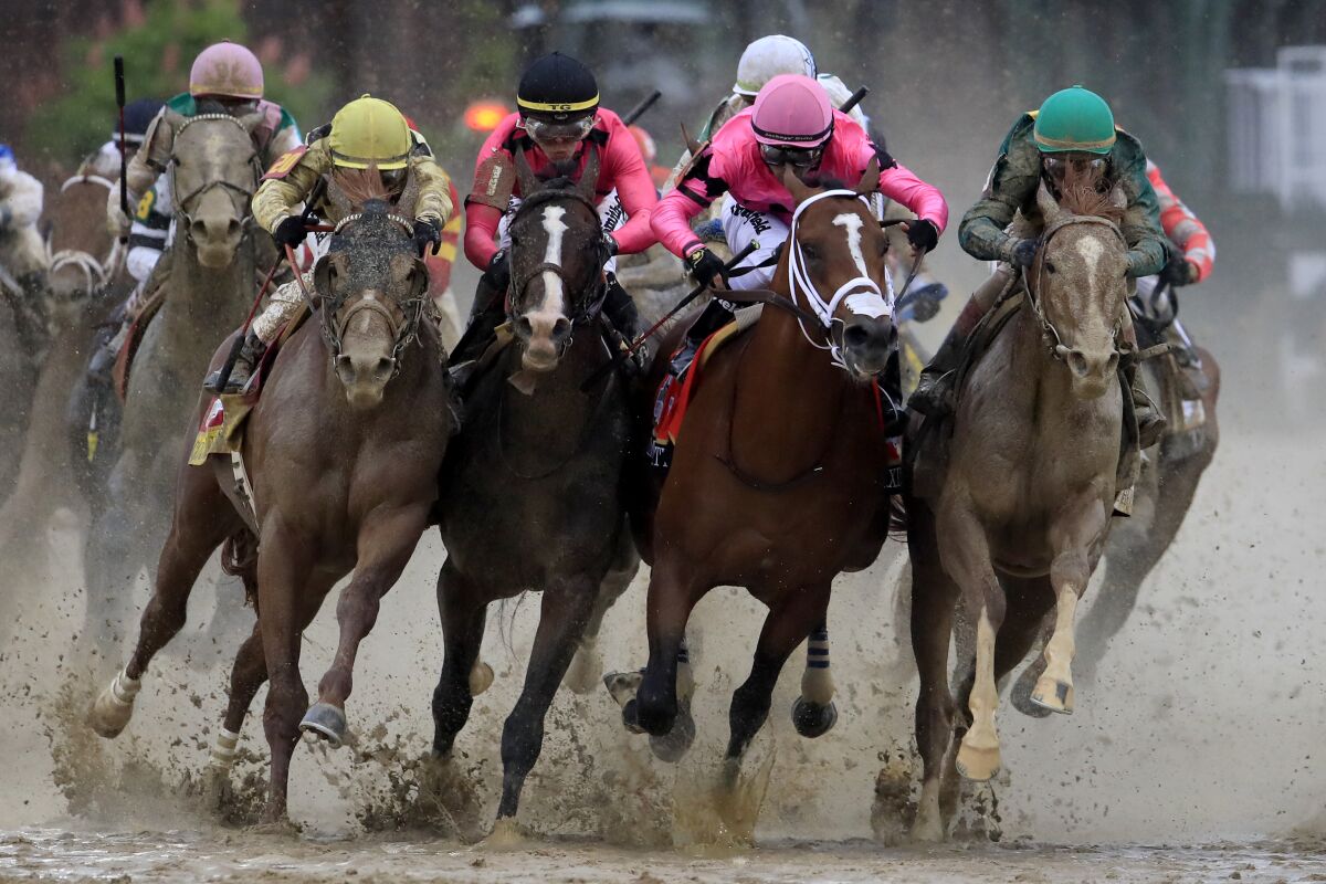Riders race with their horses at the 145th running of the Kentucky Derby at Churhill Downs on May 4 in Louisville, Ky.