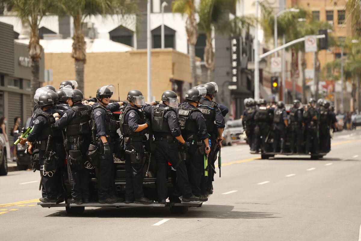 LAPD officers roll up Cahuenga Boulevard in Hollywood to control protesters.