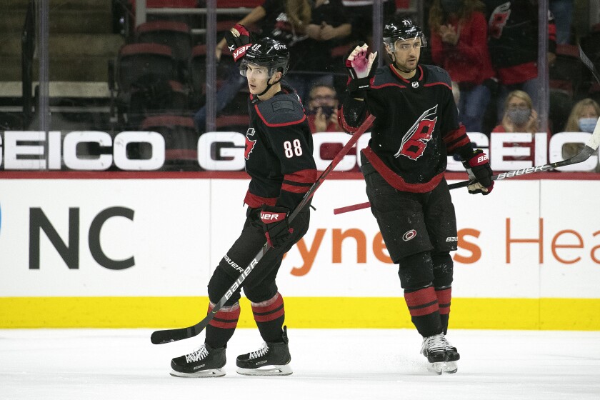 Carolina Hurricanes' Martin Necas (88) celebrates his goal with teammate Nino Niederreiter (21) during the first period of an NHL hockey game against the Chicago Blackhawks in Raleigh, N.C., Monday, May 3, 2021. (AP Photo/Karl B DeBlaker)